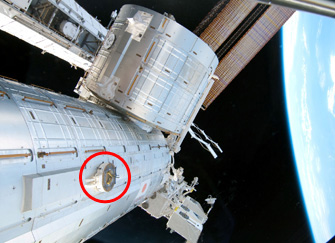 The red circle on the photo indicates a PDGF attached to the Japanese Experiment Module 