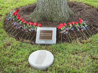 Roses laid at the foot of the tree and a replica of Neil’s first footstep on the moon.
