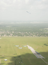 T-38s flying over the Johnson Space Center in the “missing man formation”