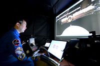 Noguchi operates a simulator (Credit: JAXA)