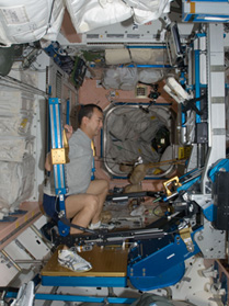 An astronaut performing exercise in the International Space Station. (Photo by JAXA/NASA)