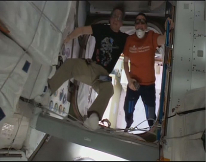 Astronauts working in the Pressurized Logistics Carrier (PLC)
