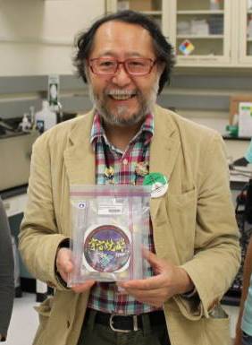 Professor Hideyuki Majima, holding returned onboard items.