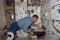 ディスカバリー号の調理設備で食事を選ぶダグラス・ウィーロック宇宙飛行士（飛行7日目）