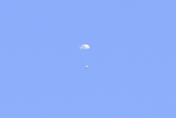 写真：パラシュートで降下中のカプセル