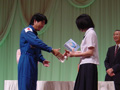 Astronaut Doi presenting a prize to a winner