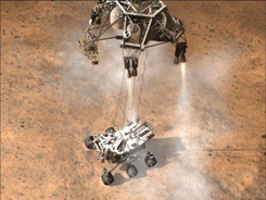 スカイクレーンで吊るされ逆噴射で降下し、火星表面にタッチダウンの瞬間の想像図。約2秒後にワイヤーが火工品で切られスカイクレーンは離れた地点へ落下する。（提供NASA/JPL-Caltech）